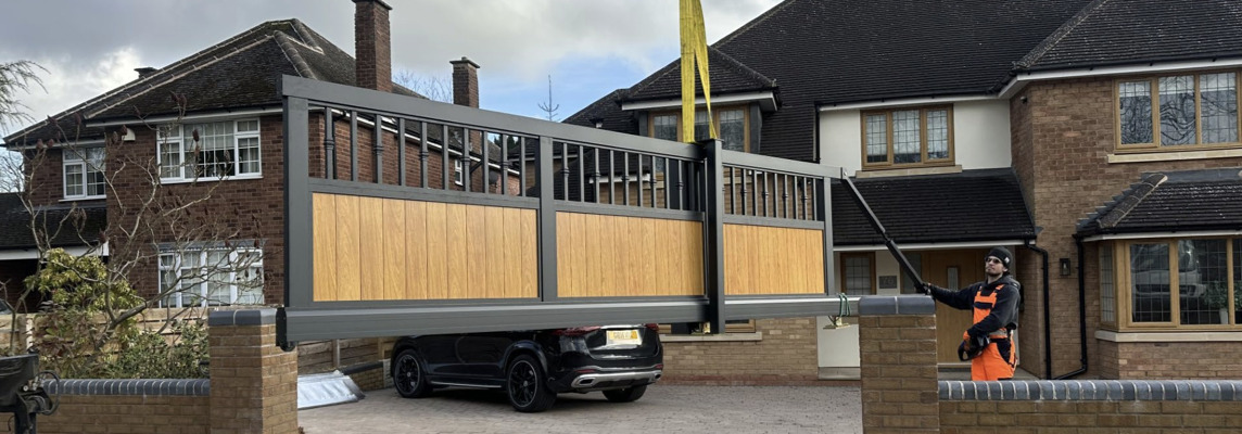 Electric sliding driveway gate being installed outside a West Midlands home