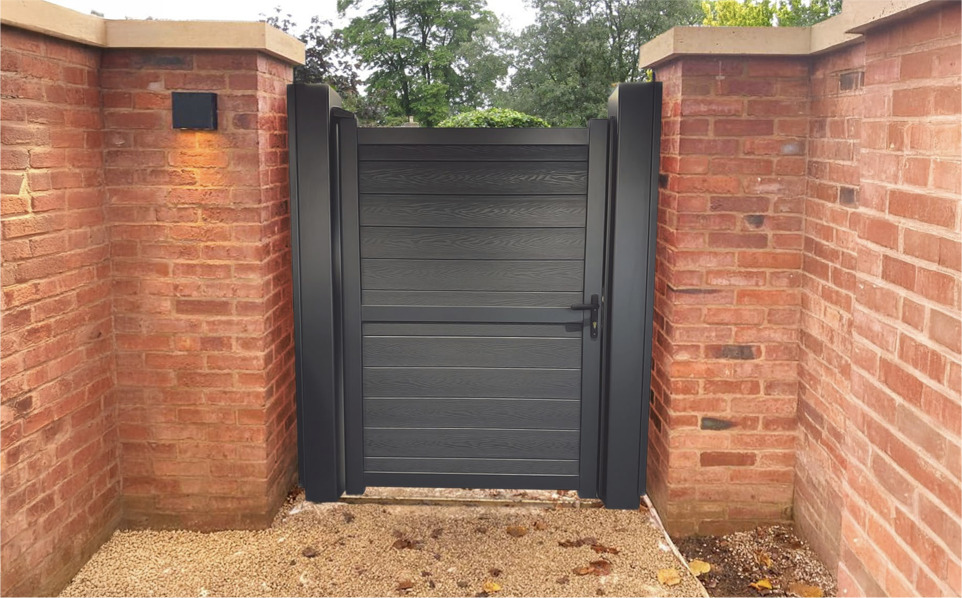 Composite pedestrian gate installed between brick pillars